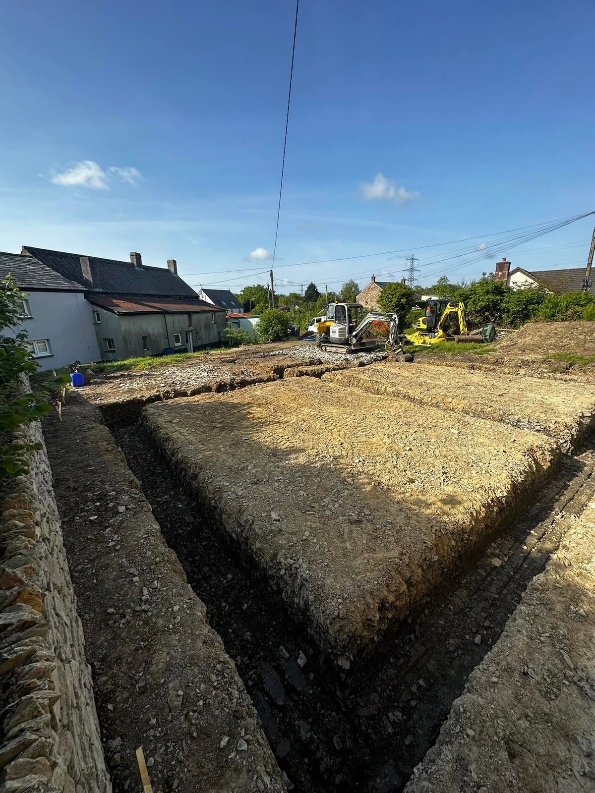 Excavated foundation trenches around a building footprint