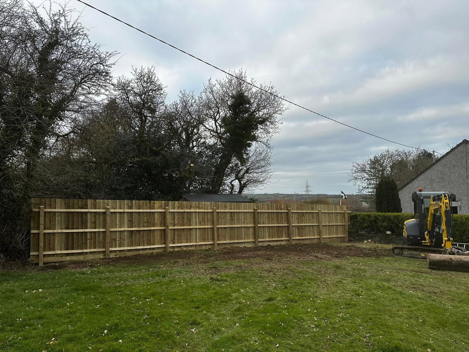 Timber panel fencing along the edge of a grassed garden