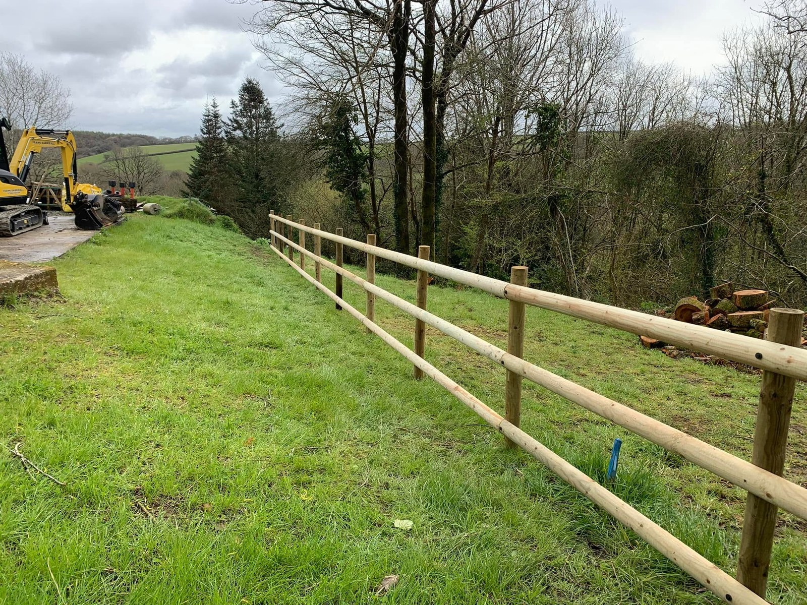 New timber post-and-rail fence beside a rural access lane