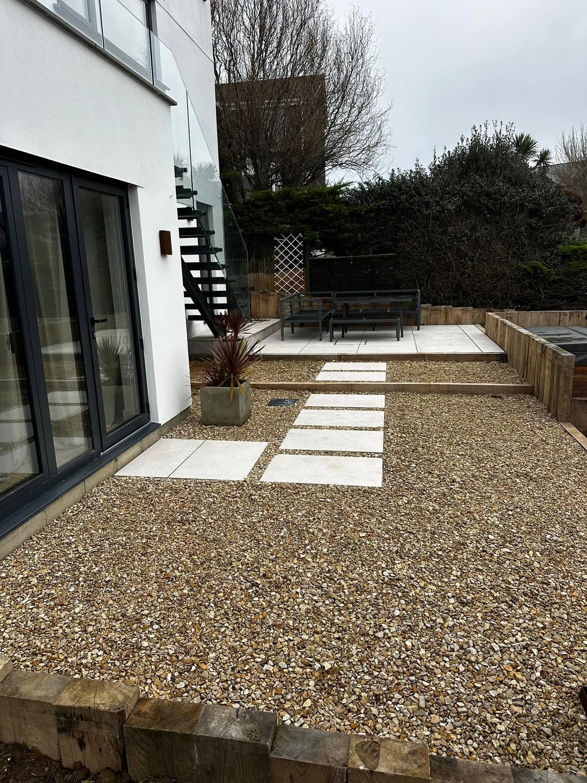 Pale paved stepping areas set into a finished gravel garden